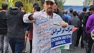 عکسی از مرد کفن پوش در راهپیمایی ۱۳ آبان